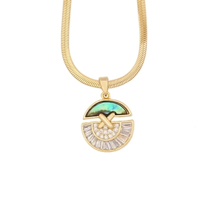 Macro shot of gold butterfly necklace pendant with abalone shell and cubic zirconia stones