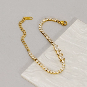 Detail of 3mm gold tennis bracelet with cubic zirconia and 18K hallmark engraving
