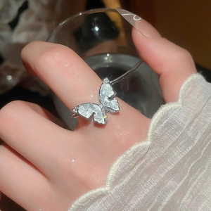 Detail of 14k gold plated butterfly ring with zircons on model's finger