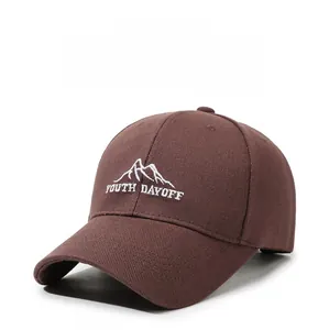 Detail of dark brown baseball cap with Youth Dayoff mountain embroidery and curved brim