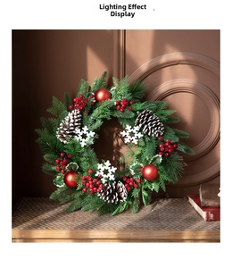Detailed view of Christmas wreath with pine cones, red berries and snowflake ornaments