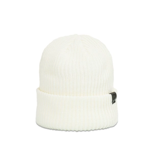 Detail view of the ribbed knit white beanie featuring a leather patch with a metal rivet
