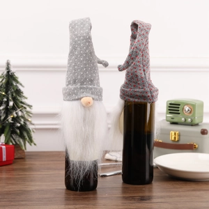 Detail of grey polka dot knitted gnome wine bottle covers with white faux fur beards