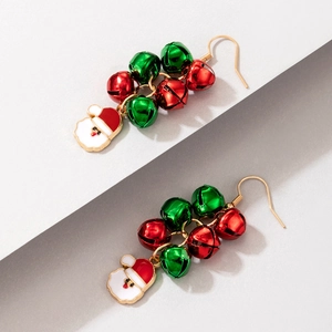 Close-up of Christmas earrings with red and green bells and Santa Claus charms