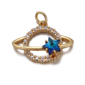 Detail of gold planet pendant with blue-green crystal star and zircon accents