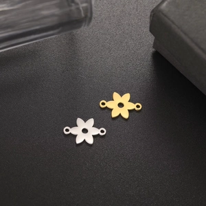 Detailed view of flower-shaped jewelry connectors in gold and silver finish