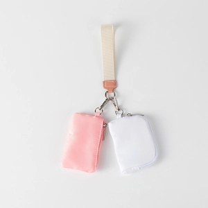 Close-up of portable wrist pouch with nylon dual mini bags and metal swivel hooks