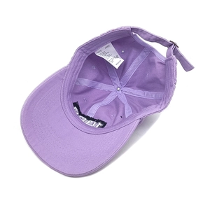 Detail of purple cotton baseball cap interior showing the white size label and neat stitching