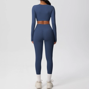 Detail view showing back of navy blue yoga set with crop top and high-waisted leggings