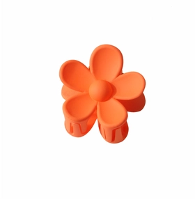 Detailed view of the bright orange matte flower hair claw clip with durable teeth