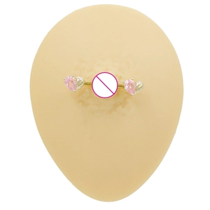 Close-up of pink heart-shaped crystal nipple ring in gold-finish on a silicone base