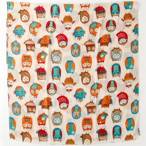 Detail of colorful cartoon owl patterns on lightweight beige linen cotton scarf