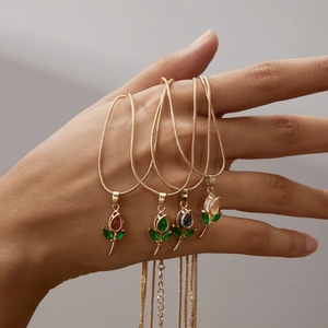 Elegant gold rose pendant necklaces featuring colorful rhinestones on a sleek snake chain