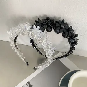 Elegant beaded flower headband with crystal pearls and shimmering petals in cold grey setting