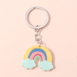 Detail of colorful rainbow keychain with cute blue clouds and a silver metal ring