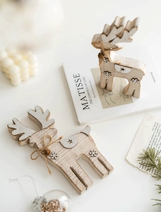 Detail of wooden reindeer ornaments with jute rope and bells in a festive setting