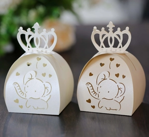 Detailed laser-cut elephant and crown pattern on ivory pearl paper candy gift box