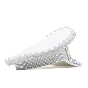 Macro detail of white captain hat with silver rhinestones and iridescent gems