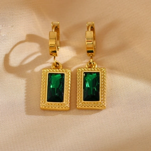 Detailed close-up of vintage gold hoop earrings with emerald-cut green zircon stones