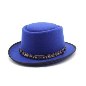 Detail of royal blue wool felt pork pie hat with ethnic pattern woven band decoration