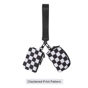 Close-up of checkered print wristlet bag with black nylon webbing and metal hardware