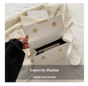 Close-up of a white flap bag interior showing capacity for a large smartphone