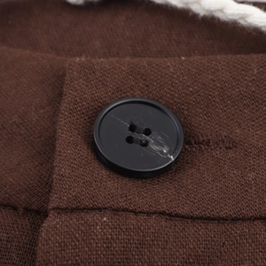 Deep brown ethnic style knit trousers with a black button and white rope belt detail