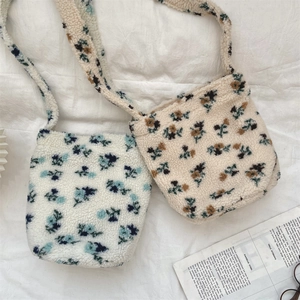 Close-up of floral fleece bucket bags with soft lamb wool texture and stylish crossbody straps