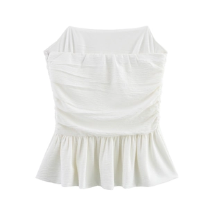 Detail of white strapless top featuring textured pleats and ruffled peplum hemline