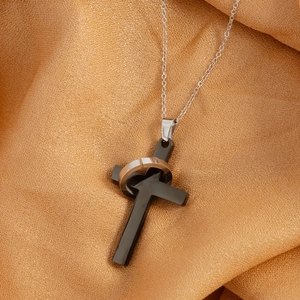 Hip hop style cross pendant necklace with rose gold ring on amber silk background