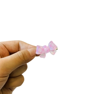 Mini iridescent pink bow hair clip with translucent shimmer finish for girls