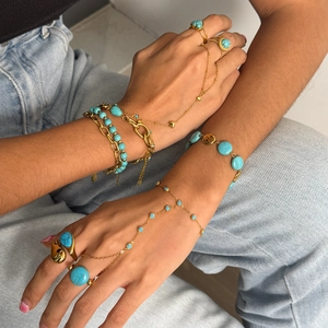 Bohemian gold plated slave bracelet with turquoise stones and rings on model hand