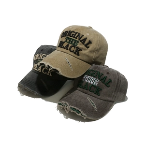 Vintage washed baseball cap with distressed brim and embroidered letters in three colors