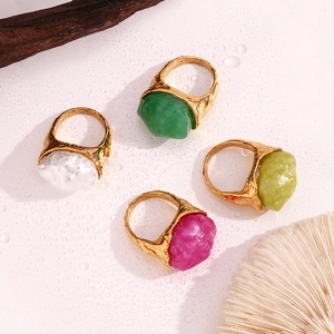 Macro detail of organic textured 18K gold rings with colorful irregular acrylic stones