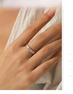 Macro shot of S925 silver moissanite ring with a pleated band design on a soft background