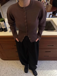 Maillard brown slim fit knitted cardigan with long sleeves on a model in a warm room