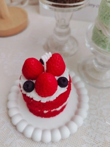 Close-up of a double-layer strawberry cream cake scented candle with realistic details