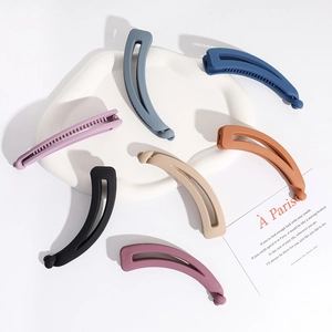 Set of 6 matte cream-colored banana clips in various pastel tones on white ceramic