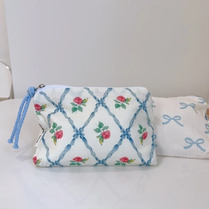 Detailed shot of floral cotton pouch with blue bow patterns and Simple Wish woven label