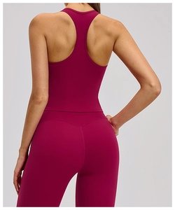 Detail view of burgundy racerback sports bra and high-waisted yoga leggings back seam