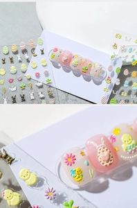 Detailed macro view of 3D Easter nail stickers with embossed bunnies and colorful eggs