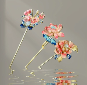 Detailed view of floral hairpins with pink and blue enamel, gold plating and pearls