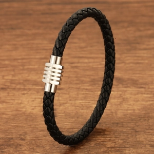 Close-up of black braided leather bracelet with a polished silver magnetic clasp