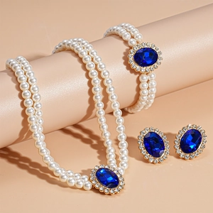 Detailed macro view of pearl jewelry set featuring blue stones and diamond accents