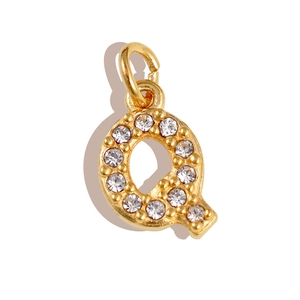 Macro shot of gold letter Q pendant featuring sparkling zircon micro-pave setting