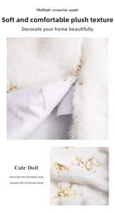 Detail of white plush Christmas tree skirt with gold sequin snowflakes and velcro closure