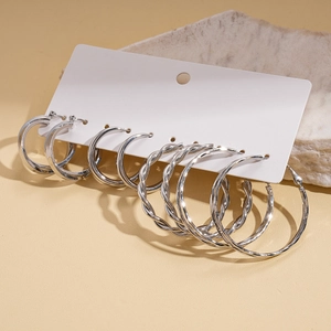 Detailed set of six silver geometric hoop earrings in polished and twisted designs