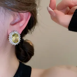 Oval yellow zircon earrings with white crystal halo in a vintage French style