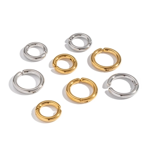 Eight minimalist 18K gold and silver stainless steel ear cuffs in various sizes on white background