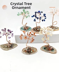 Close-up of colorful gemstone crystal trees with twisted copper wire on agate base